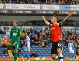 James Collins celebrates in front of the travelling Luton Town fans