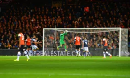 Simon Sluga claims a cross