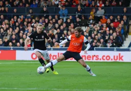 Callum McManaman stretching to keep the ball away from Andreas Weimann