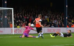 That's got to hurt, Dan Bentley saves from James Collins' effort at goal