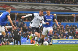 Ryan Tunnicliffe advances through midfield away from Lukas Jutkiewicz
