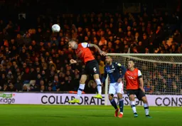 Sonny Bradley clears his lines with a towering header