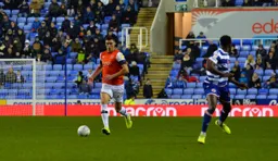 Lloyd Jones brings the ball out of defence during one of his rare league starts for the Hatters