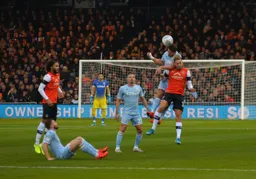 Harry Cornick challenges for an aerial ball but misses out