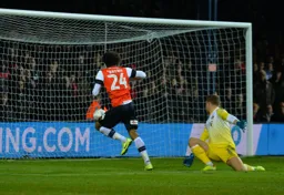 Dillon Phillips looks at his goal after Izzy Brown has slid the ball past him into the net, making it 2-1