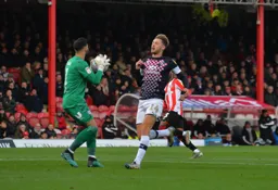 Harry Cornick can't get to the ball ahead of David Raya