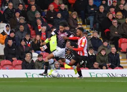 Izzy Brown going round the outside of Rico Henry