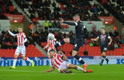 Ryan Tunnicliffe lifting the ball over the onrushing Danny Batth