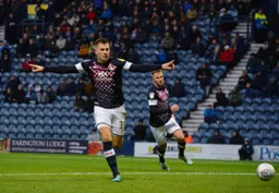 James Collins wheels away celebrating after netting the Towns' equaliser from the spot