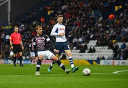 Callum McManaman about to receive the ball with Paul Gallagher closing in