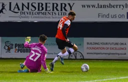 Harry Cornick rounds Freddie Woodman but can't find the back of the net