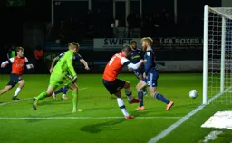 Ryan Tunnicliffe has rounded the keeper and tries his luck from the tightest of angles, hitting the post