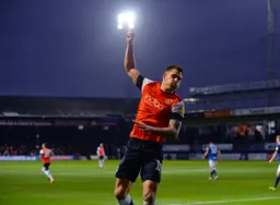James Collins punches the floodlight after levelling the match