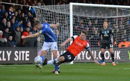 James Collins trying to win the ball back from Will Vaulks in the Cardiff box