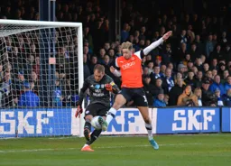 Harry Cornick gets a challenge in on Alex Smithies as he tries to clear the ball