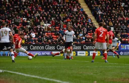 Harry Cornick has a pop at goal and scores, future Hatter Tom Lockyer can't block the ball