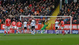 Simon Sluga and the travelling Hatters look worried, but Naby Sarr's close range effort is about to cannon off the crossbar