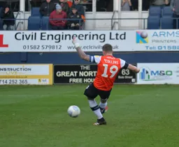 James Collins slots home a 90th minute penalty to equalise for the Hatters