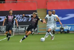 Harry Cornick whips round the outside of Matt Grimes