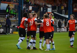 Luton Town players celebrating the goal that made it 3-1