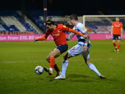 Harry Cornick holds the ball up as Lyndon Dykes closes in