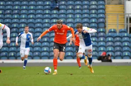 Harry Cornick bursts forward with the ball