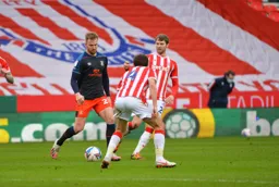 James Bree moves forward to take on Joe Allen