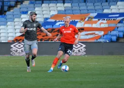 Kal Naismith brings the ball out of defence