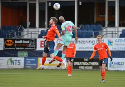 Ryan Tunnicliffe in an aerial dual with Andre Ayew