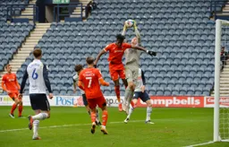 Daniel Iverson grabs the ball of Elijah Adebayo`s head