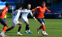 Ryan Tunnicliffe is closed down by Romal Palmer