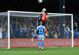 Fred Onyedinma challenges the Peterborough goalkeeper