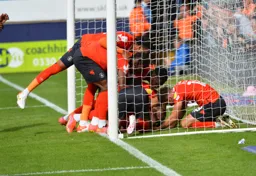 The players celebrate with Harry Cornick after he opens his account on the opening day of the season