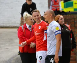 Past and Future Hatter Cauley Woodrow leads his Barnsley team out alongside Kal Naismith