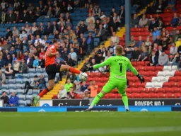 Harry Cornick trying to get the ball past future Hatter Thomas Kaminski