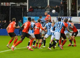 Sonny Bradley rises highest in the box