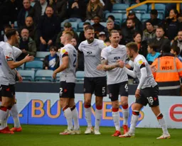 Luton Town players celebrate the opening goal