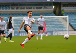 Tom Lockyer drives the ball