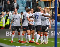 The players celebrate Cornick's brace