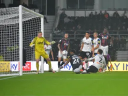 Fred Onyedinma heads in for the Hatters