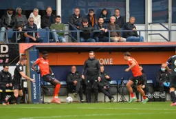 Elijah Adebayo lays the ball off for Harry Cornick as Nathan Jones watches on