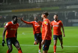 Players run to celebrate with Harry Cornick