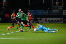 A cross is sent in, but the keeper gathers before Fred Onyedinma or Elijah Adebayo can capitalise