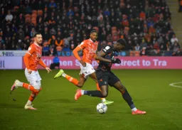 Elijah Adebayo charging forward with Blackpool defenders giving chase