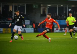 Jordan Clark plays a pass through midfield