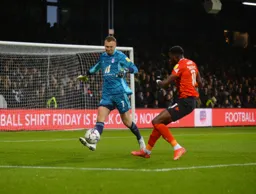 Elijah Adebayo closes down the keeper