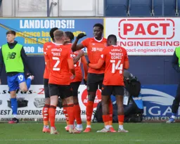 The team celebrating with Elijah Adebayo after he opens the scoring