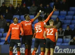 The Town players celebrating in front of the travelling Hatters