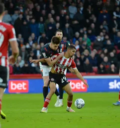 Reece Burke getting touch tight with Ilman Ndiaye