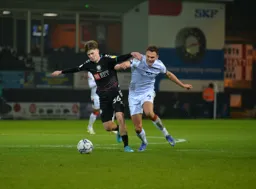 Kal Naismith battling for the ball with Alex Scott